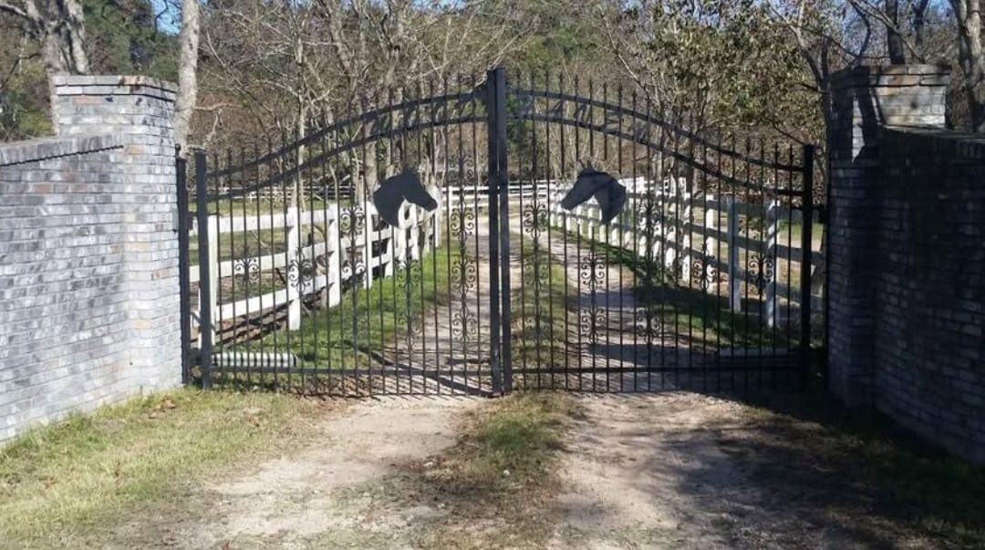 Arched ranch entry gate with brick columns